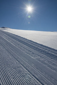 Scenic view of snowcapped landscape against clear blue sky