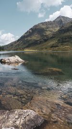 Scenic view of lake and mountains against sky