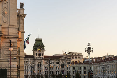 Buildings in city against clear sky