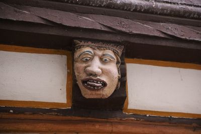 Low angle view of sculpture on wall