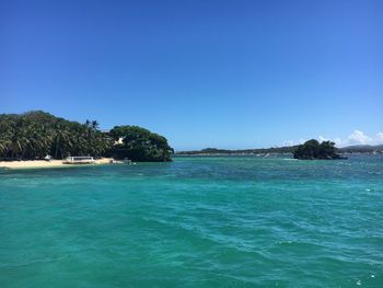Scenic view of sea against clear blue sky