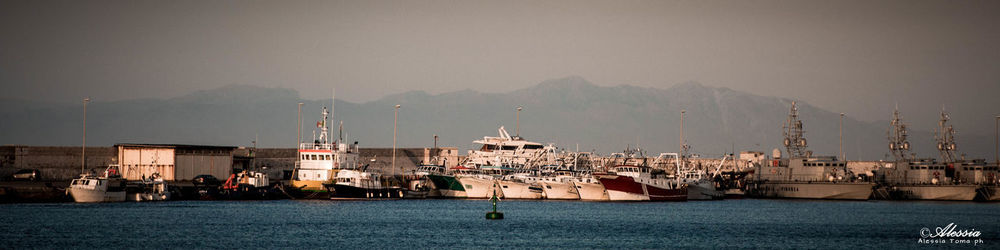 Panoramic view of sea and cityscape against sky