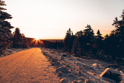 Scenic view of field against clear sky during sunset