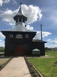 View of bell tower against cloudy sky