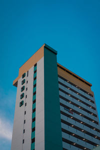 Low angle view of modern building against clear blue sky