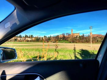 Scenic view of field seen through car window