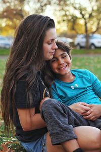 Portrait of a smiling young woman sitting outdoors