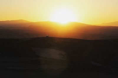 Scenic view of silhouette mountains against sky during sunset