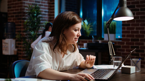 Young woman using laptop at office
