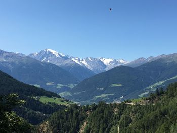 Scenic view of mountains against clear blue sky