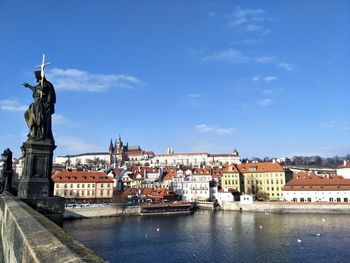 Statue of buildings against cloudy sky