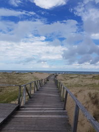 Pier over sea against sky