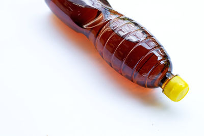 Close-up of bottle on table against white background