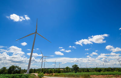 Windmill on field against sky