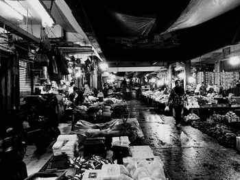 People at market stall at night