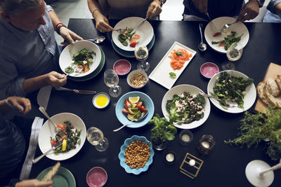 High angle view of multi-ethnic friends eating food at table