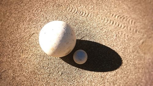 High angle view of hockey and golf balls on field