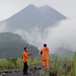 Rear view of men standing on mountain road