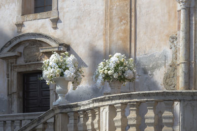 Romantic wedding bouquet in a baroque stone vase in taormina in sicily in italy