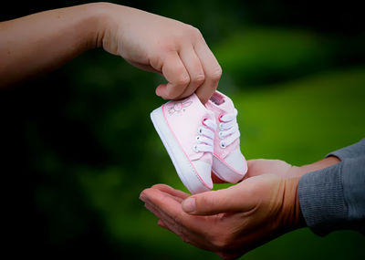 Close-up of hand holding paper outdoors