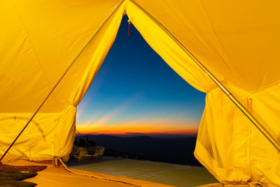 Tent against sky during sunset