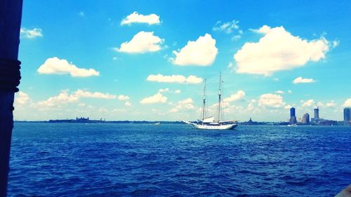 Sailboat sailing on sea against sky
