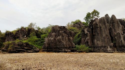 Rock formations on landscape against sky