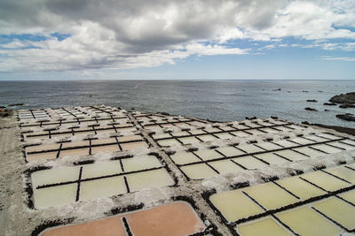 High angle view of sea salt shore against sky