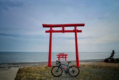 Bicycle on beach against sky