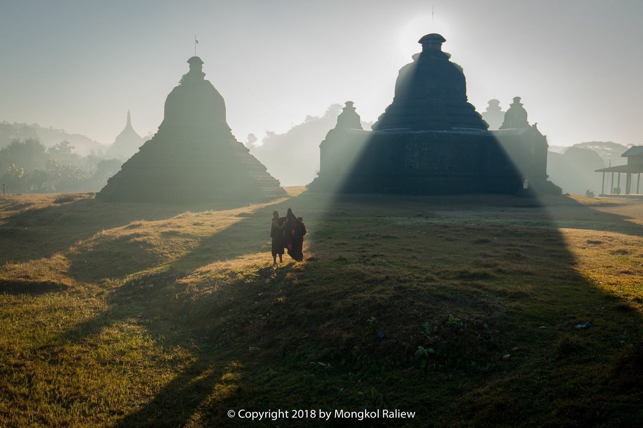 architecture, built structure, building exterior, real people, sky, nature, mountain, sunlight, day, building, history, travel, the past, travel destinations, religion, men, plant, place of worship, spirituality, beauty in nature, outdoors