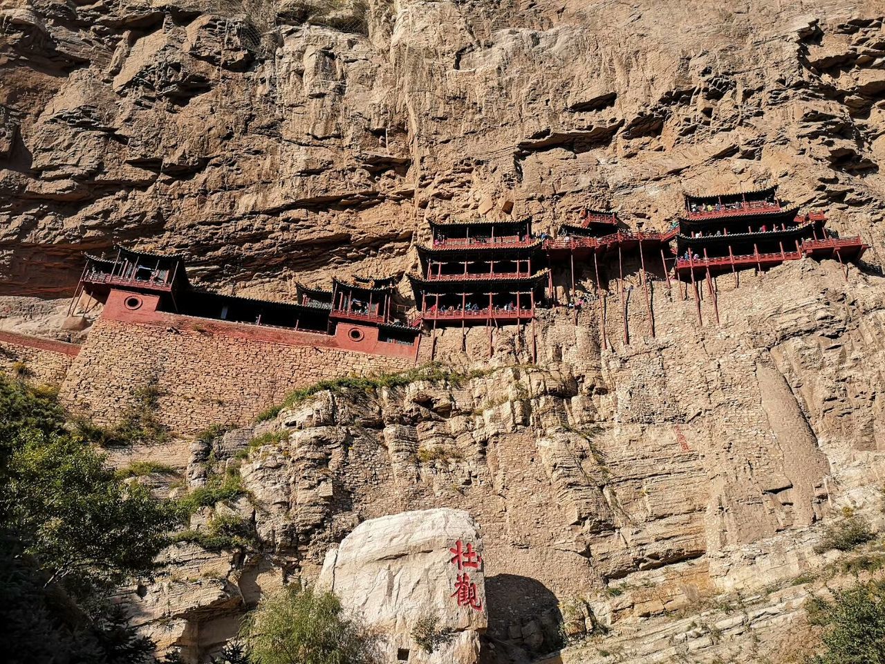 LOW ANGLE VIEW OF RED ROCKS AND BUILDINGS