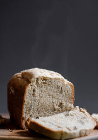 Close-up of bread on table against black background