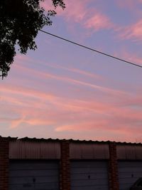 Low angle view of building against sky during sunset