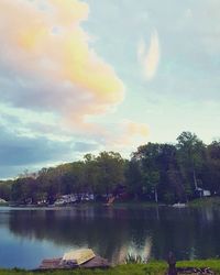 Scenic view of lake against cloudy sky