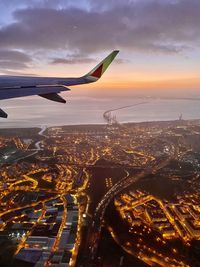 Aerial view of city against sky during sunset