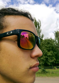 Close-up of sunglasses against sky