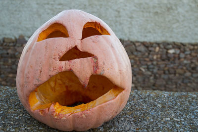 Close-up of pumpkin on pebbles