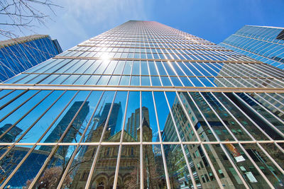 Low angle view of modern building against blue sky