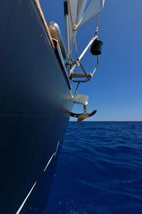 Sailboat sailing on sea against clear sky