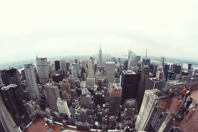 Fish eye view of cityscape against sky