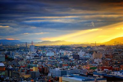 High angle view of illuminated cityscape against sky during sunset