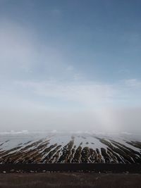 Scenic view of land against sky during winter