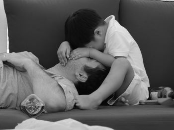 Mother and girl relaxing on bed at home
