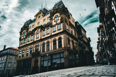 Low angle view of buildings in town against sky