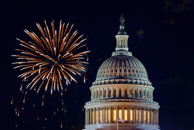 Low angle view of firework display at night