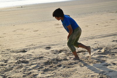 Full length of boy on sand at beach
