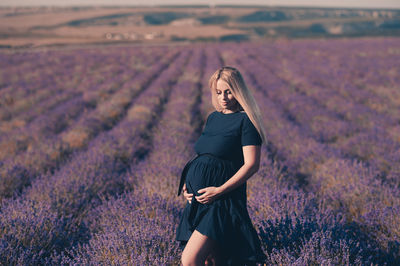 Pregnant woman standing on field