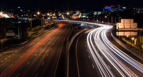 High angle view of light trails on road at night