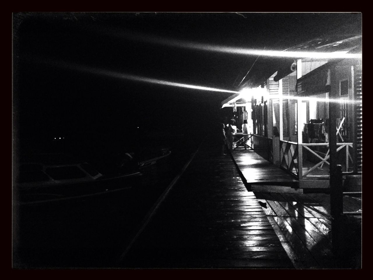 transfer print, illuminated, transportation, lifestyles, the way forward, architecture, built structure, railing, auto post production filter, night, men, walking, diminishing perspective, full length, rear view, person, leisure activity, building exterior