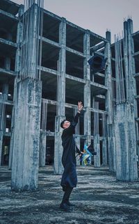 Full length of boy standing against building